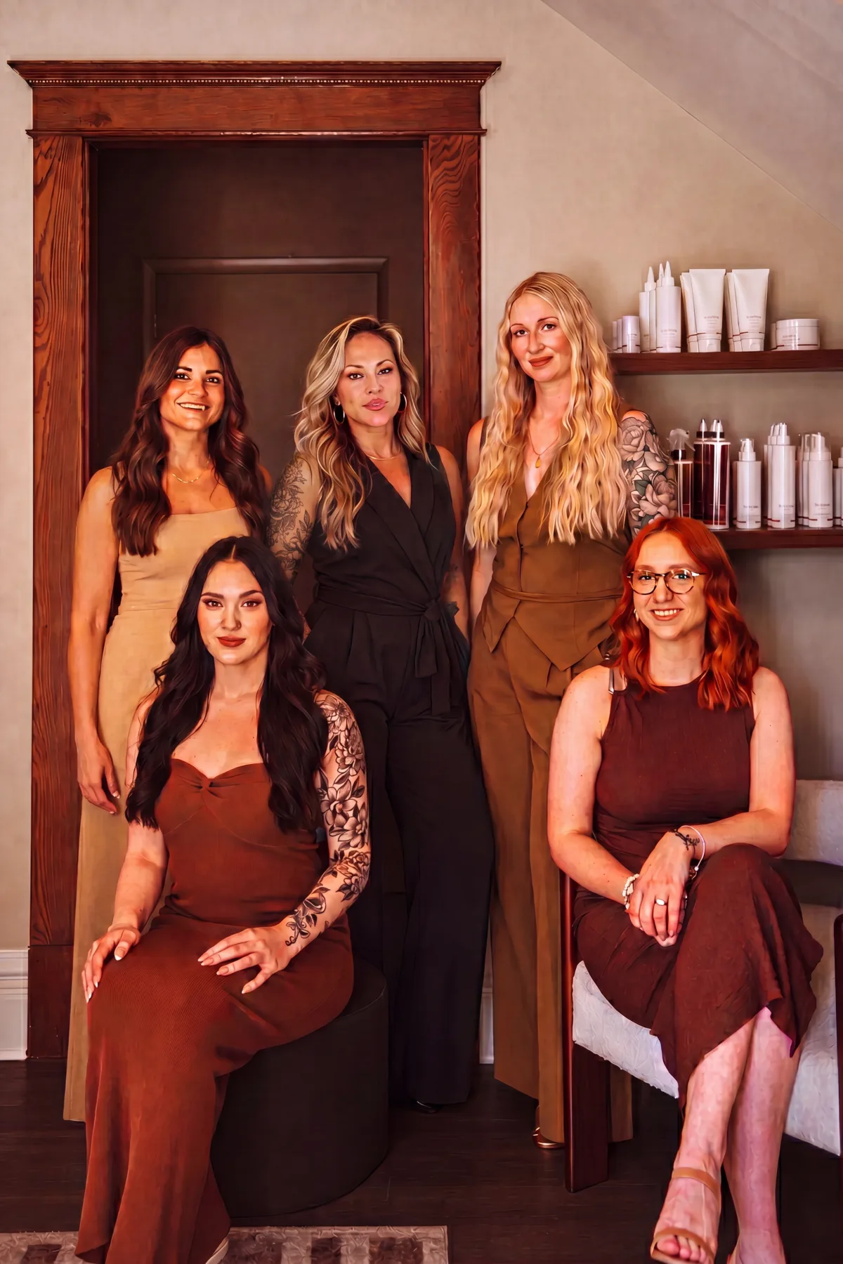 The artists of Patina Salon framed in the doorway